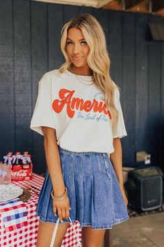 – Light up the skies this summer in our casual but cute tee – Lightweight cotton material with a red and blue patriotic graphic design – Round neckline – Short loose sleeves – Slouched silhouette that falls into a straight unfinished hemline Retro Summer T-shirt For Day Out, Retro American Flag Print Summer T-shirt, Summer Crew Neck T-shirt, Summer Flag Print T-shirt With Relaxed Fit, Summer Americana T-shirt With Relaxed Fit, Summer Americana Relaxed Fit T-shirt, White Retro Top For 4th Of July, Summer Americana Style Relaxed Fit T-shirt, Retro Cotton Tops For Summer