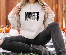 Momster Sweatshirt, Halloween Sweatshirt, Halloween Mom Shirt, Mom Sweater, Fall Sweatshirt, Spider Web Sweater, Mom Gift ---How To Order--- 1-) Please, check and review all photos 2-) Choose your t-shirt size and color 3-) Click add to cart. You can go back to add more product 4-)Click "Proceed to check out" 5-)When you check out, you can add a note to seller for any request Unisex Unisex t shirt fits like a well-loved favorite, featuring a crew neck, short sleeves and designed with superior airlume combed and ring-spun cotton that acts as the best blank canvas for printing. Features: Side seamed. Retail fit. Unisex sizing. Shoulder taping Women's Tank Top Women's racer back tank top made with blended semi-sheer fabric. * 4.0 oz., 60% combed ring-spun cotton/40% polyester * Self-fabric bi Spider Web Sweater, Momster Sweatshirt, Funny Halloween Tshirt, Halloween Moms, Halloween Crewneck, Mom Sweater, Halloween Tshirt, Sweatshirt Halloween, Halloween Shirts