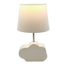 a white table lamp with a cloud shaped shade on the base and a light bulb at the end