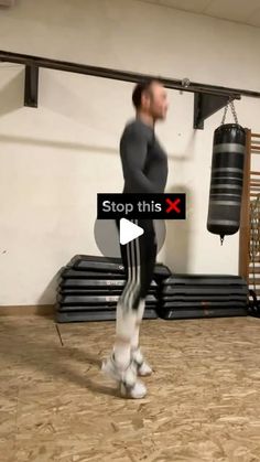 a man standing in front of a punching bag with the words stop this x on it