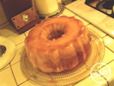 a glazed donut sitting on top of a glass plate