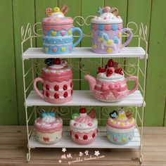 a three tiered shelf with teapots and cups on it's sides