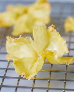 some yellow flowers are sitting on a cooling rack and it is not yet wilting