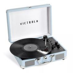 an open suitcase with a record player in it and the word victoria printed on top