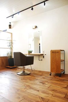 a hair salon with wooden floors and white walls