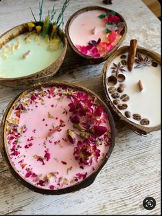 four bowls filled with different types of candles