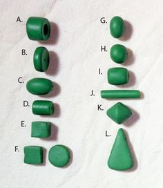 green plastic objects are shown on a white sheet