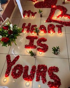 flowers and candles are laid out on the floor to spell i love you's