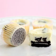 two pieces of cake sitting on top of a white plate next to a oreo cookie