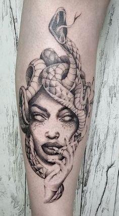 a woman with a snake on her head is shown in this black and white tattoo