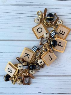 a bracelet with wooden blocks and letters on it