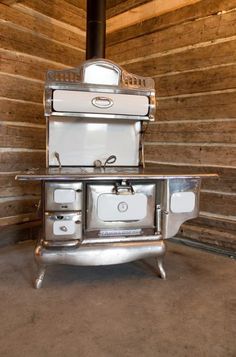 an old fashioned stove sitting in the corner of a room