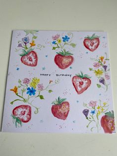 a birthday card with strawberries and flowers on the front, which reads happy birthday