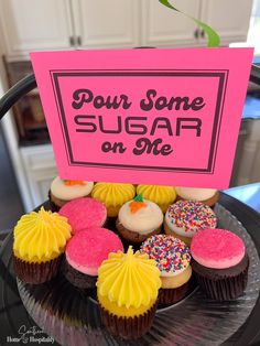 cupcakes with frosting and sprinkles are displayed on a plate