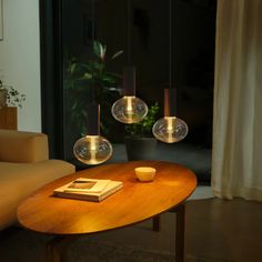 a table with some lights on it and a book in front of the coffee table