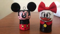 two mickey and minnie mouse salt and pepper shakers with red bows on their heads