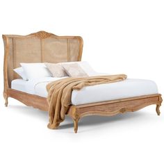 a bed with wicker headboard and foot board on top of it, in front of a white background