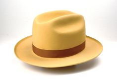 "Fedora | The BELLAGIO | Styled and finished by hand Customize it to match your physical characteristics and lifestyle. Personalize it to reflect your unique statement. At a glance: - Available in any color combination from our swatches - Tried and true handmade quality - Fits your exact head measurement comfortably - Delivered safely inside a real hat box - Includes a protective organic cotton drawstring bag - Comes with care instructions - Three delivery options Specifications: - Classic fedor Classic Yellow Hat With Short Brim, Real Hat, Womens Western Hats, Wide Brim Hat Men, Physical Characteristics, Fedora Hat Men, Mens Fur, Hat Men, Hat For Men