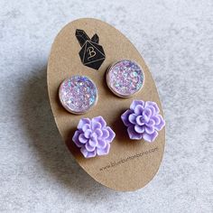 "This beautiful, lavender purple earring set features succulent flowers and iridescent glitter druzy geodes in silver bezel trays, both set on silver stud posts.  Both pairs of earrings measure approximately 1/2\" in diameter. You may purchase these as a set or individually. Please make your selection from the drop-down menu prior to checkout. So pretty! Perfect given as a bridesmaids gift. I can make multiple sets upon request. ▻ Lead and nickel-free ▻ Handmade in Santa Cruz, CA To preserve the Lavender Flower-shaped Earrings For Gifts, Adjustable Purple Flower Earrings As Gift, Adjustable Purple Flower Earrings For Gift, Lavender Flower Shaped Jewelry Gift, Lavender Flower-shaped Jewelry Gift, Lavender Flower Shaped Jewelry For Gift, Lavender Flower-shaped Jewelry For Gifts, Purple Succulents, Lover Jewelry