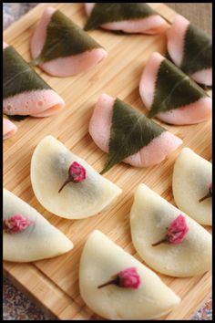 small pieces of food are arranged on a cutting board