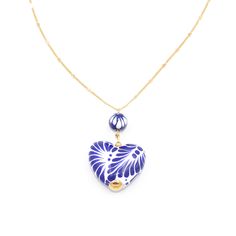 The subtle chain makes the necklace seem delicate which is a go to when looking for something that can look both elegant and classy at the same time! The Talavera heart as well as the Talavera bead has been handmade and takes lots of time and patience. Our Mexican artisans dedicate valuable time of their lives to be able to make this gorgeous product just for you! Handmade Jewelry Made with Clay, Stainless Steel, and 14k gold plated.  Colors used: Cobalt blue, white, and gold. Measurements: Leng Elegant Blue Heart Necklace, Blue Heart Pendant Clavicle Chain Jewelry, Blue Dainty Necklace With Heart Charm, Dainty Blue Necklace With Heart Charm, Dainty Blue Heart-shaped Necklace, Blue Heart Pendant Necklace As Gift For Her, Blue Heart Shaped Clavicle Chain Necklace, Blue Heart-shaped Clavicle Chain Necklace, Blue Heart Clavicle Chain Necklace