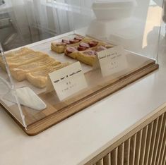 several different types of food on display in a glass case