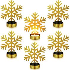 gold snowflakes are arranged in the shape of candles