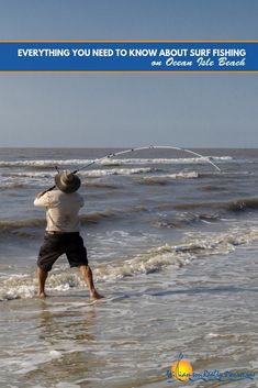 a man standing on top of a beach next to the ocean holding a fishing pole