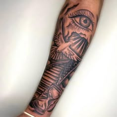 a man's arm with an all seeing eye tattoo on it