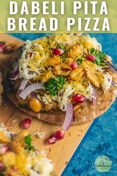 a pizza topped with cheese and vegetables on top of a wooden cutting board