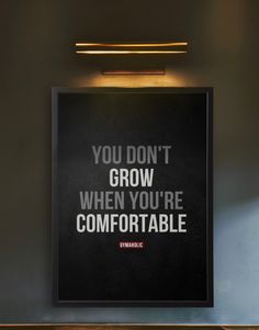 a black poster with the words you don't grow when you're comfortable