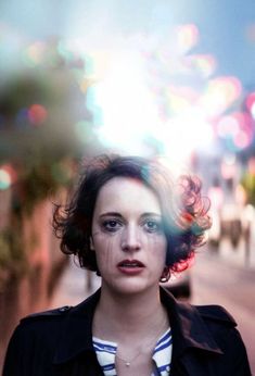 a woman standing in front of a city street with the words fleabag on it