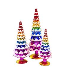 three colorful glass christmas trees sitting on top of each other