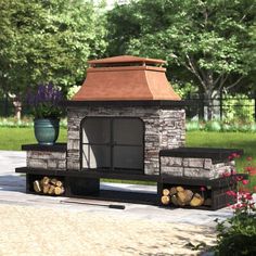 an outdoor fireplace with logs in front of it