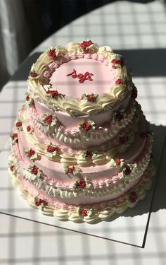 there is a large cake with pink frosting on it