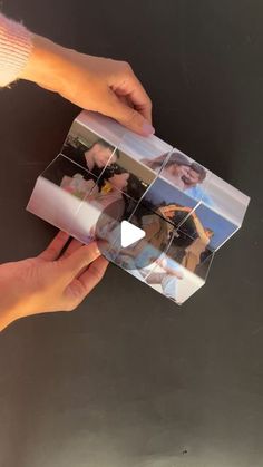 two hands holding an open photo album