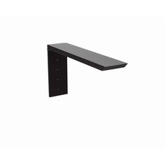 a black shelf sitting on top of a white wall next to a metal object with two holes in it