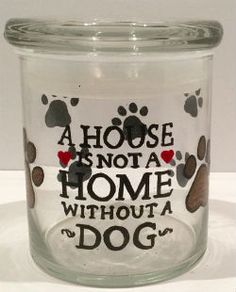 a glass jar with a dog print on it's lid and the words, a house is not a home without a dog