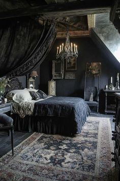 a bedroom with black walls and an ornate bed in the center, chandelier hanging from the ceiling