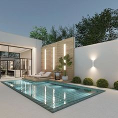 an outdoor swimming pool with lounge chairs and lights on the wall next to it at night