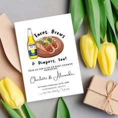 a beer and some tulips are on the table next to a greeting card