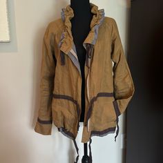 This Is A Really Cute 100% Linen Jacket To Wear Casually Or Dress Up. Ribbon Synch Detail Around Collar, Waist, And Hip. Sleeves End With A Bit Of A Bell Shape. Zipper In Front. Khaki And Beige In Color. Hits Below Waist. Like Brand New. Only Wore A Couple Of Times. Been In A Box, Needs To Be Steamed. Bohemian Brown Outerwear With Pockets, Beige Lagenlook Long Sleeve Outerwear, Brown Spring Outerwear For Layering, Brown Outerwear For Spring Layering, Beige Lagenlook Outerwear For Fall, Brown Cotton Outerwear For Layering, Bohemian Brown Outerwear For Layering, Bohemian Beige Outerwear With Pockets, Bohemian Khaki Outerwear For Spring