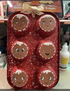 an egg carton with six decorated eggs in the shape of santa's faces