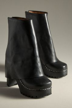 Leather upper, insole Rubber sole Pull-on styling Imported | Bootcut Foldover Boots by Swedish Hasbeens in Black, Women's, Size: 40, Leather/Rubber at Anthropologie Modern Leather Platform Boots With Stacked Heel, Designer Boots With Pointed Toe And Rubber Heel Cap, Leather High Ankle Wedge Boots With Lug Sole, Designer Ankle Platform Boots With Leather Sole, Leather High Ankle Platform Boots With Stacked Heel, Leather Wedge Ankle Boots With Lug Sole, Modern Leather Platform Boots With Sculpted Heel, Calf Leather High Heel Platform Boots With Reinforced Heel, Designer Platform Boots With Reinforced Heel And Round Toe