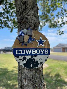 a wooden sign hanging from the side of a tree