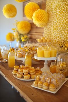 dessert table with honeycombs and cupcakes on it