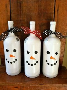 three white bottles with snowmen painted on them