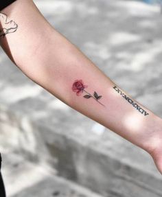 a person with a rose tattoo on their arm