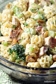 a bowl filled with macaroni salad and broccoli