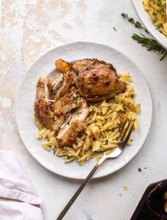 chicken and rice on a plate with a fork